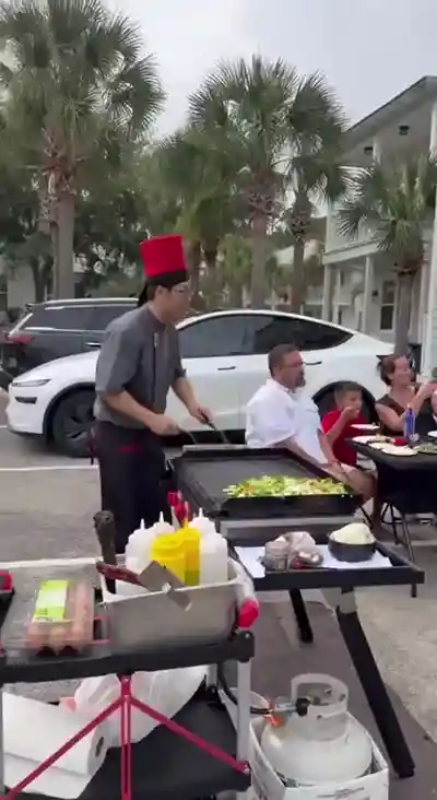 Live hibachi performance with fire at vacation rental party